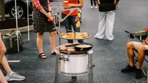 People tailgating around a breeo fire pit