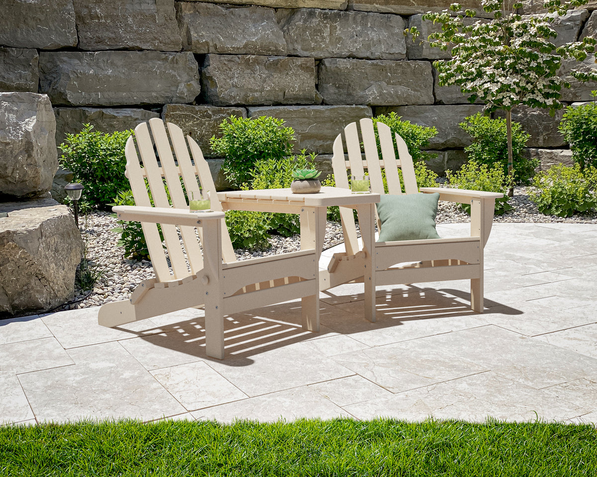 POLYWOOD Classic 3-Piece Folding Adirondack Set With Connecting Table in Sand in an outdoor setting
