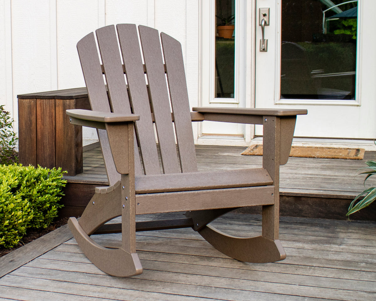 POLYWOOD Nautical Adirondack Rocking Chair in Vintage Sahara on a front porch beside white French doors