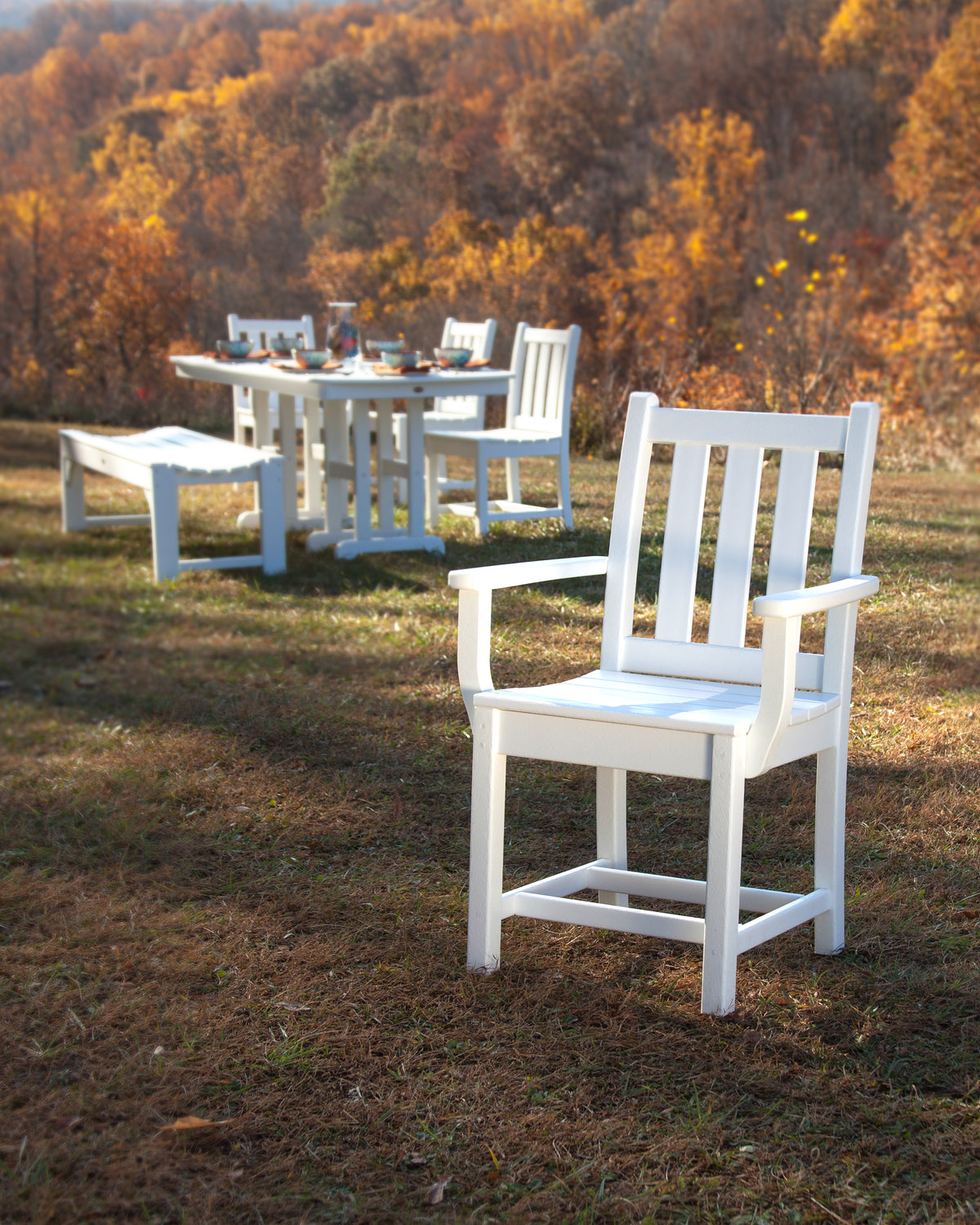 POLYWOOD Traditional Garden Dining Arm Chair in White in an outdoor setting