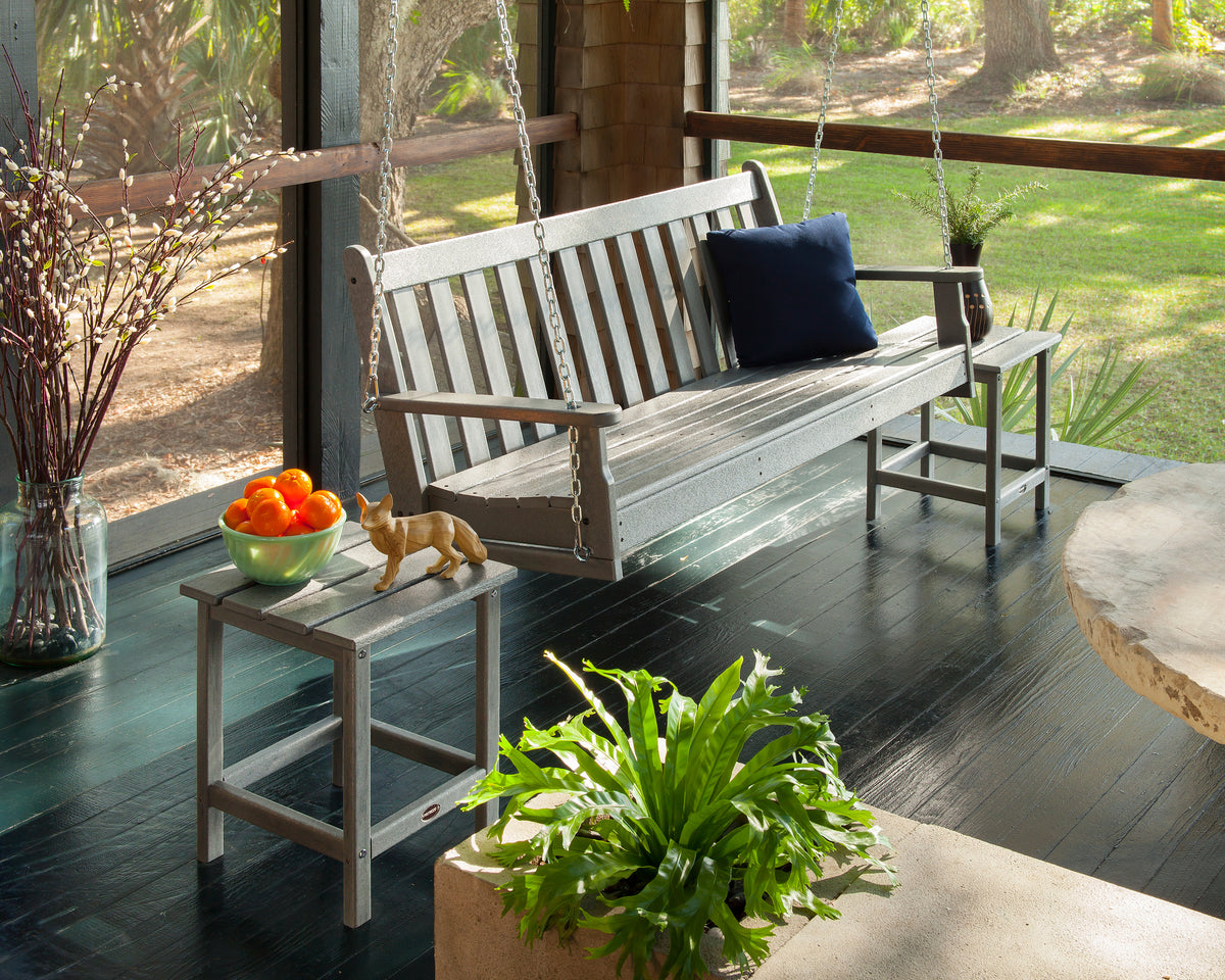 Lifestyle photo of the POLYWOOD Vineyard 60" Porch Swing in Slate Grey