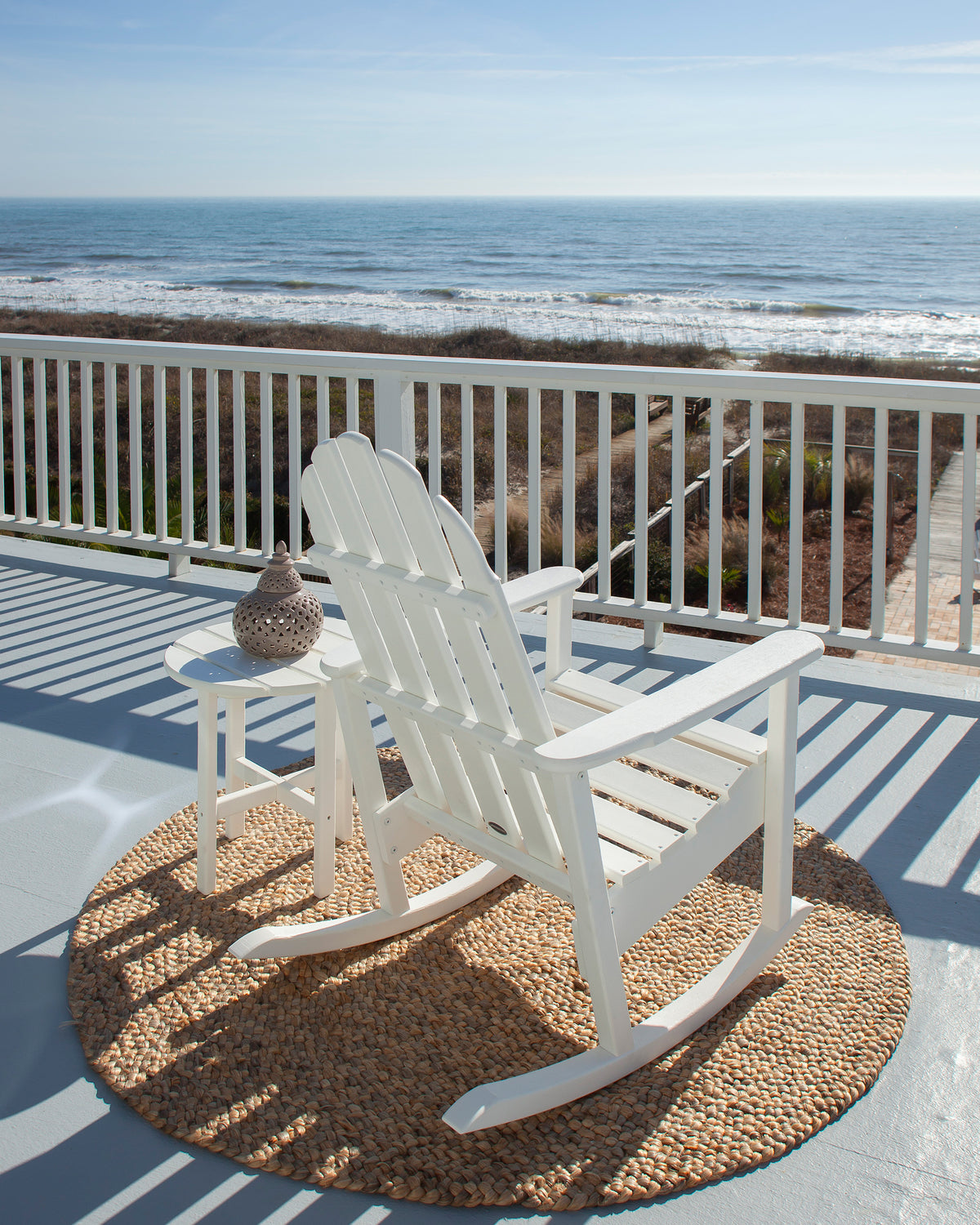 POLYWOOD Classic Adirondack Rocking Chair in White in an outdoor setting