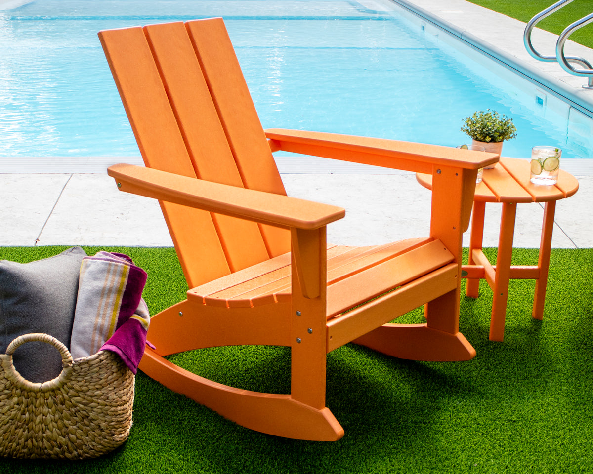 POLYWOOD Modern Adirondack Rocking Chair in Tangerine in an outdoor setting