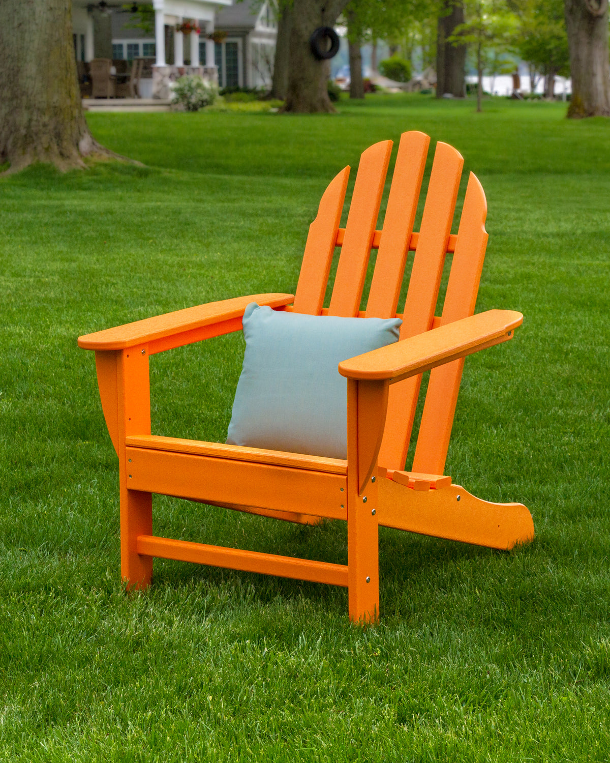 POLYWOOD Classic Adirondack Chair in Tangerine styled outdoors