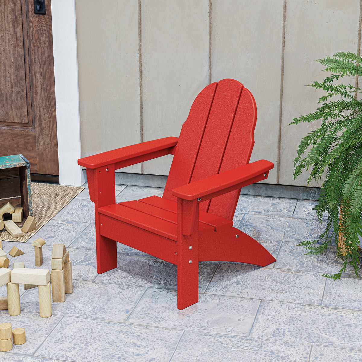 POLYWOOD Kids Vineyard Adirondack Chair in Sunset Red styled outdoors