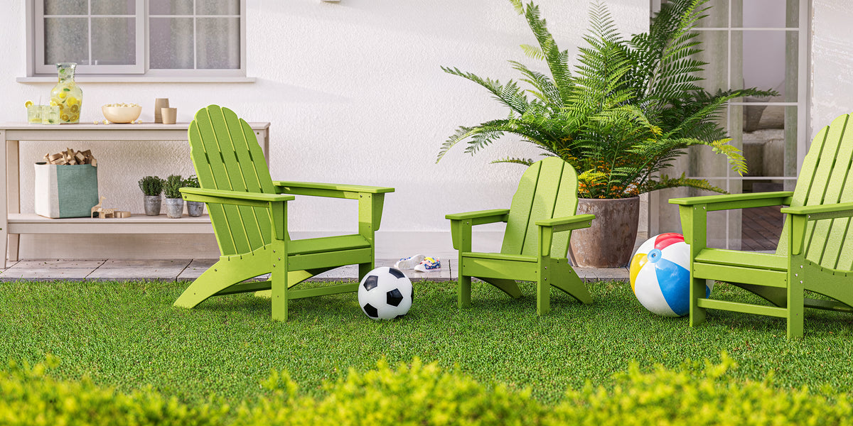 POLYWOOD Kids Vineyard Adirondack Chair in Lime in an outdoor setting