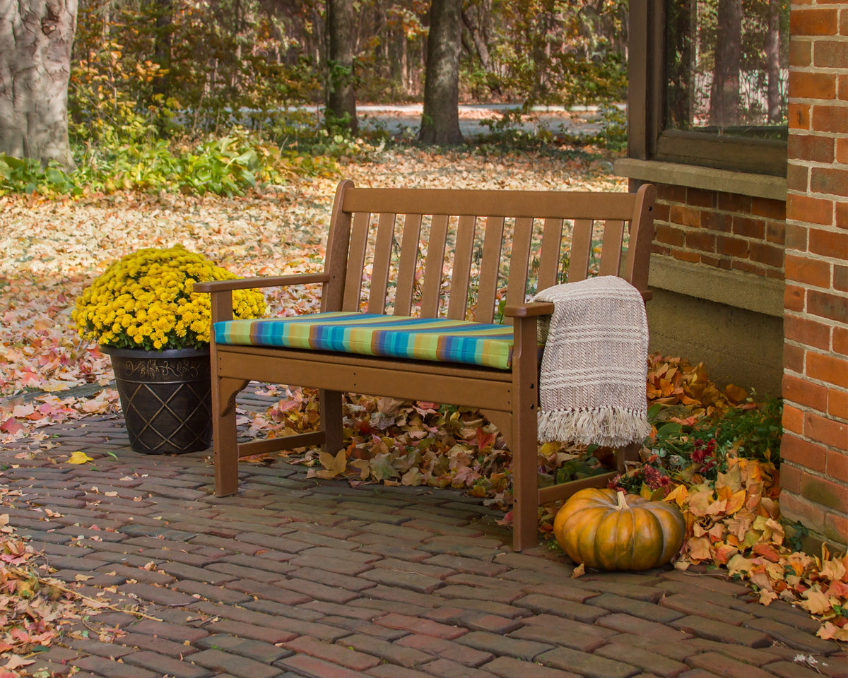 Lifestyle photo of the POLYWOOD Vineyard 48" Bench in Teak