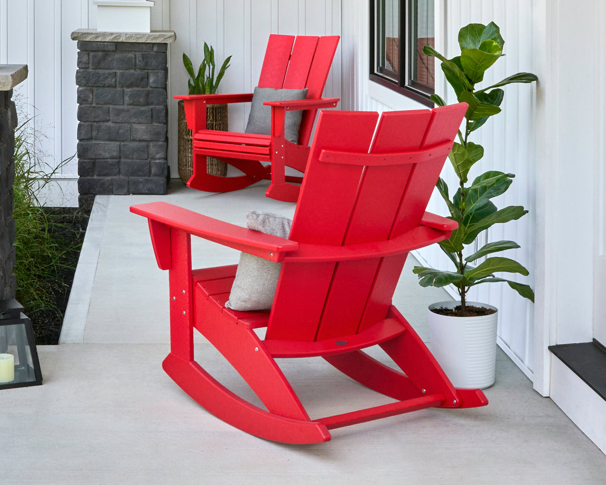 POLYWOOD Modern Curveback Adirondack Rocking Chair in Sunset Red in an outdoor setting