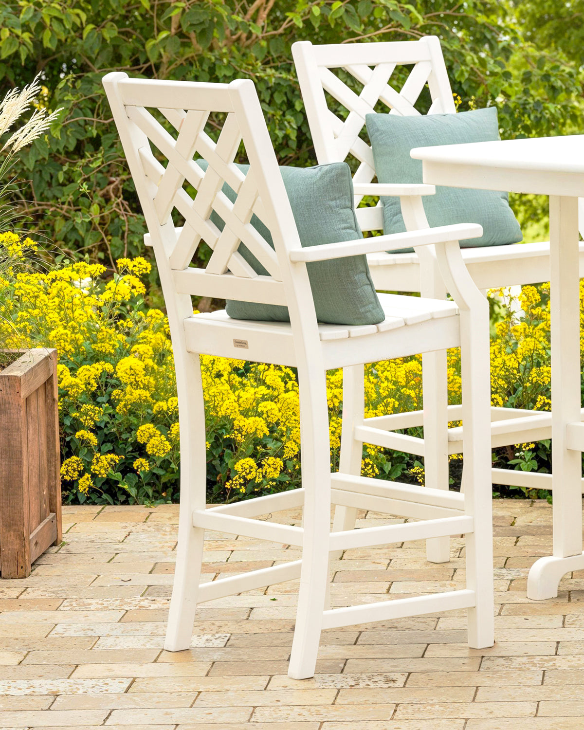 Lifestyle photo of the POLYWOOD Wovendale Bar Arm Chair in White