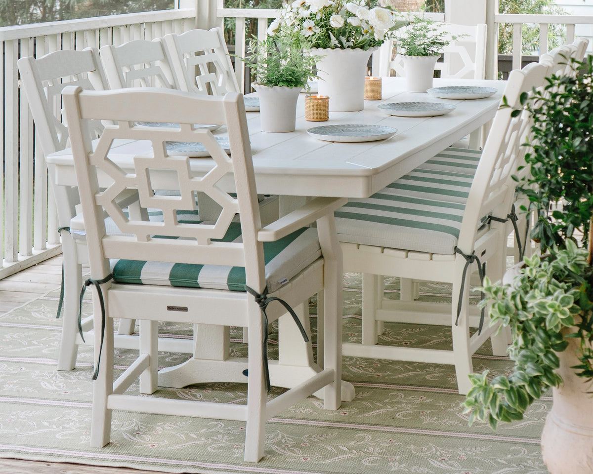 Lifestyle photo of the POLYWOOD Chinoiserie 9-Piece Dining Set with Trestle Legs