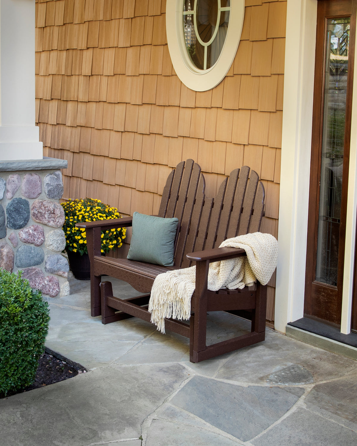 POLYWOOD Classic Adirondack 48" Glider in Mahogany in an outdoor setting