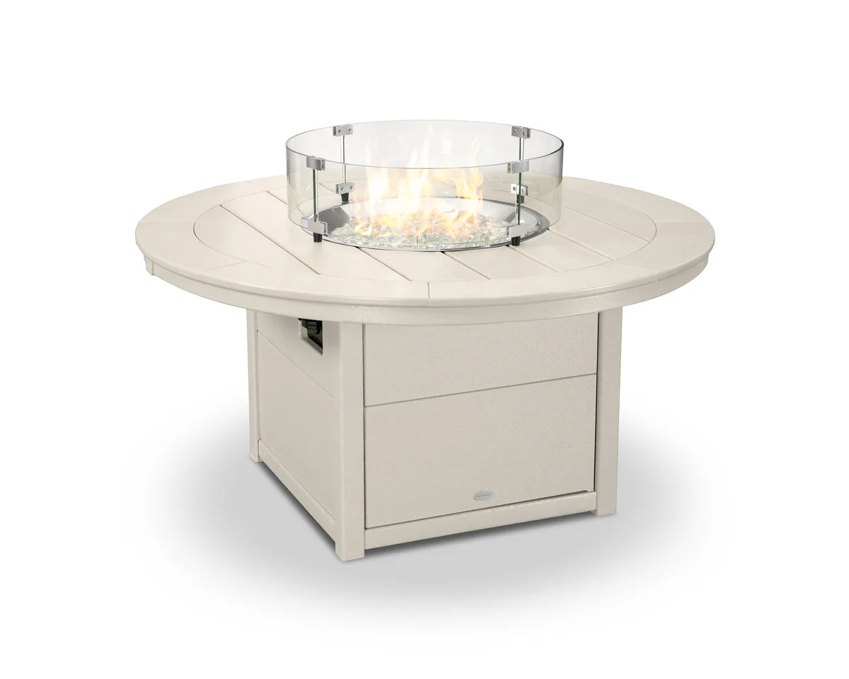 Round outdoor fire table with glass top on a white background