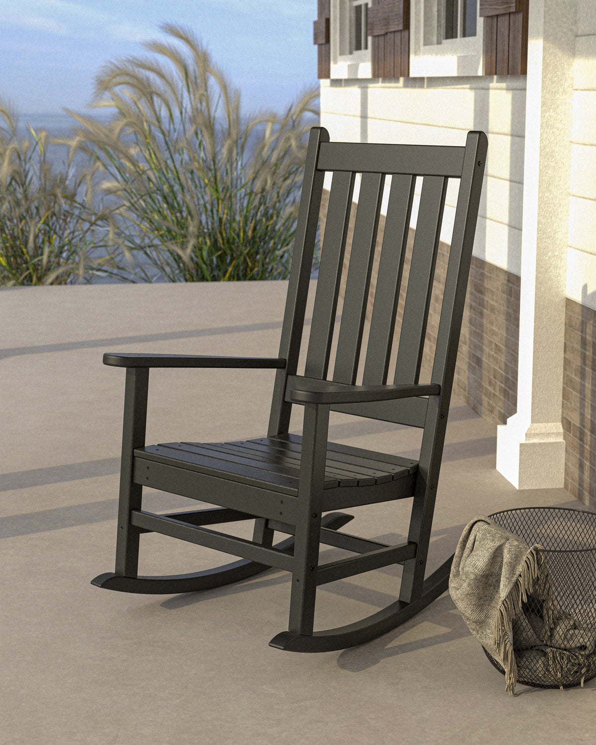 POLYWOOD Vineyard Porch Rocking Chair in Black in an outdoor setting