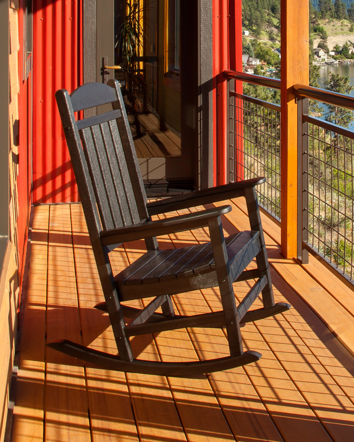 Lifestyle photo of the POLYWOOD Presidential Rocking Chair in Black