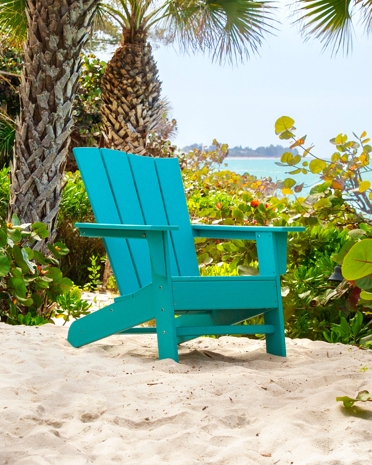 Lifestyle photo of the POLYWOOD The Wave Chair Left in Aruba