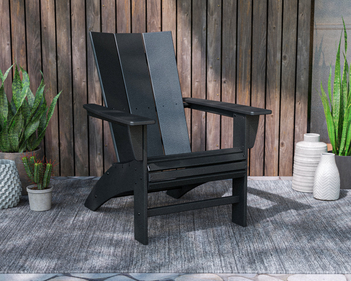 Lifestyle photo of the POLYWOOD Modern Curveback Adirondack Chair in Black