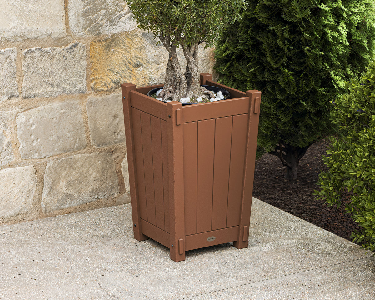 POLYWOOD Vineyard Tapered Square Short Planter Box in Teak in an outdoor setting