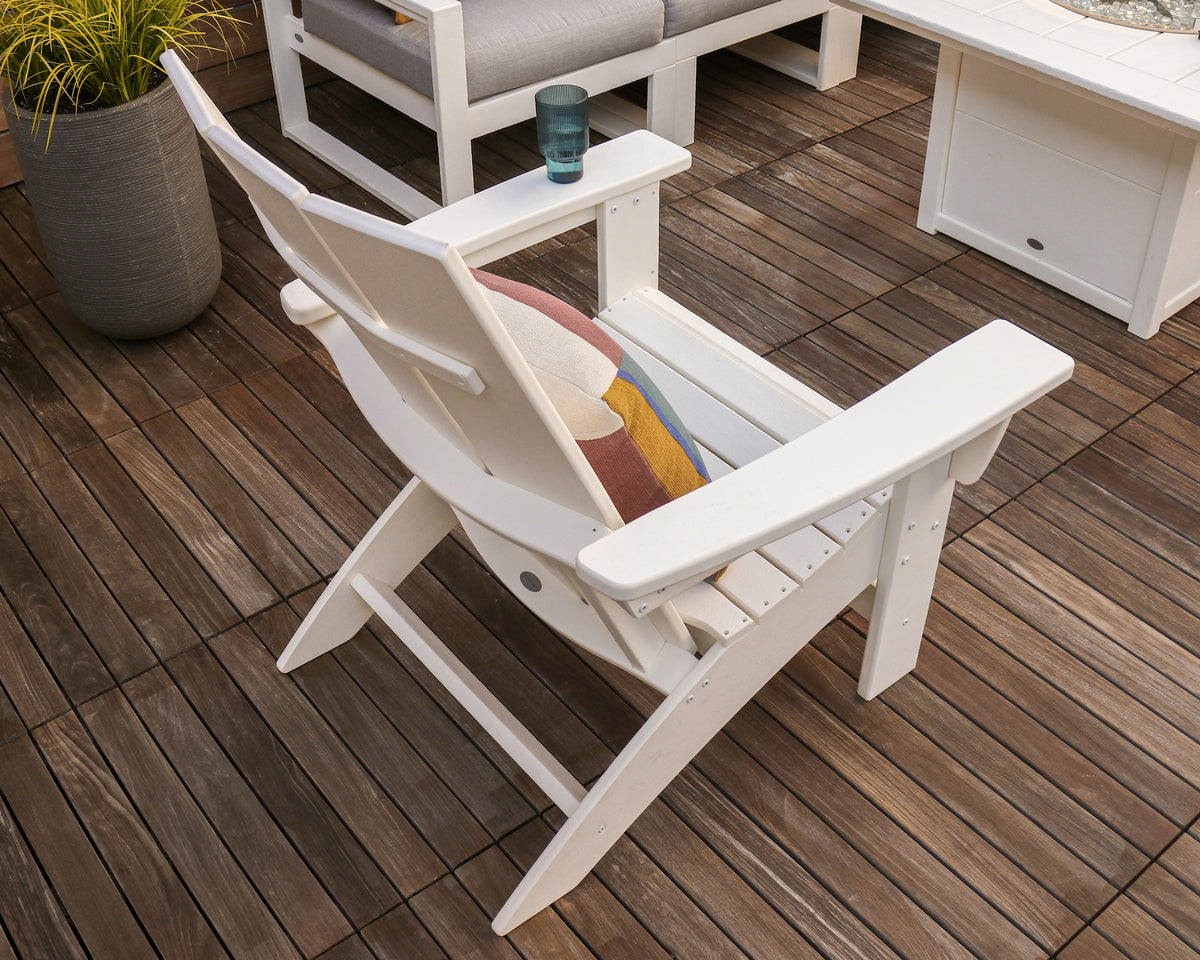 Lifestyle photo of the POLYWOOD Modern Grand Adirondack Chair in White