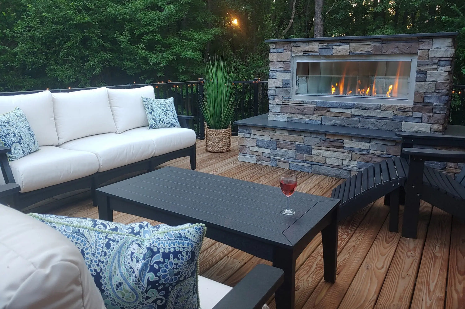 A view setting of outdoor furniture around an outdoor fireplace