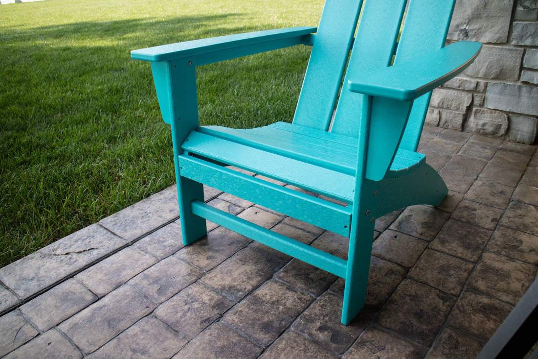 POLYWOOD Modern Adirondack Chair in Aruba, front three-quarter view on patio