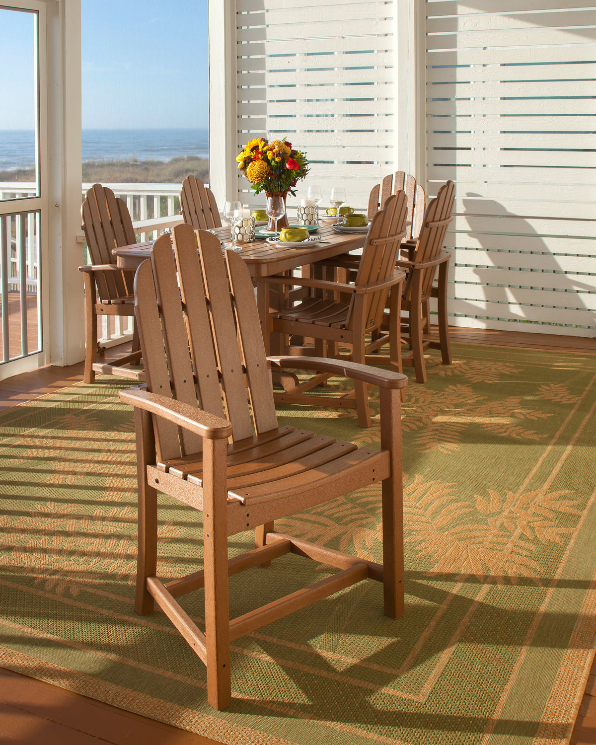 POLYWOOD Classic Adirondack Dining Chair in Teak in an outdoor setting
