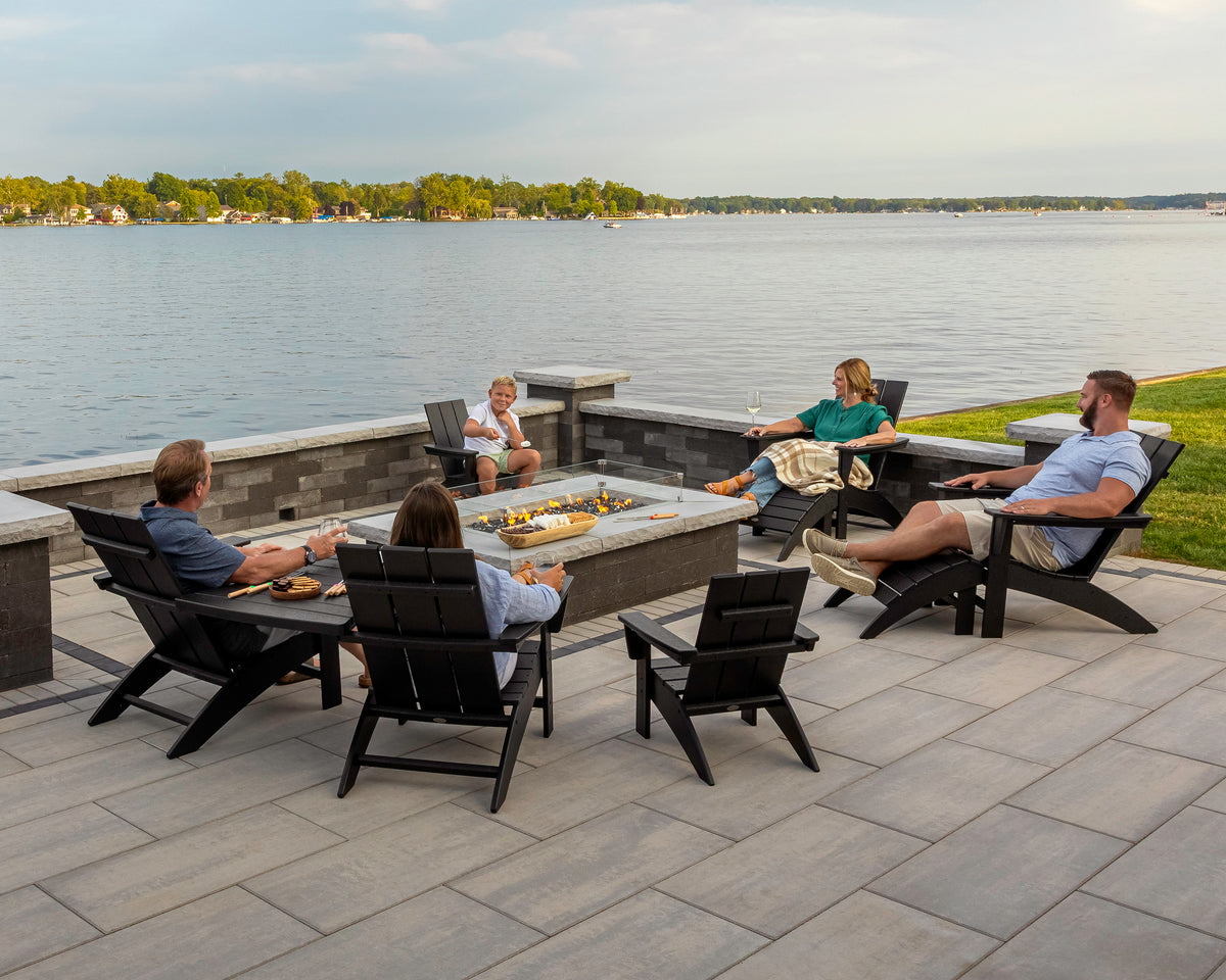 POLYWOOD Vineyard Adirondack Ottoman in Black in an outdoor setting