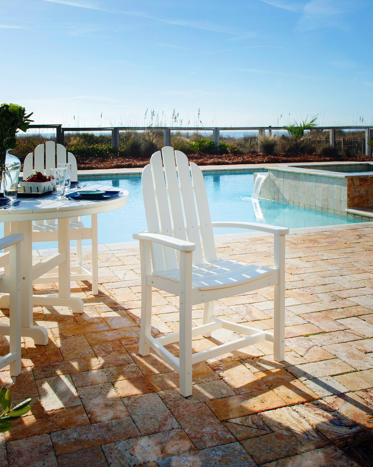 POLYWOOD Classic Adirondack Dining Chair in White styled outdoors