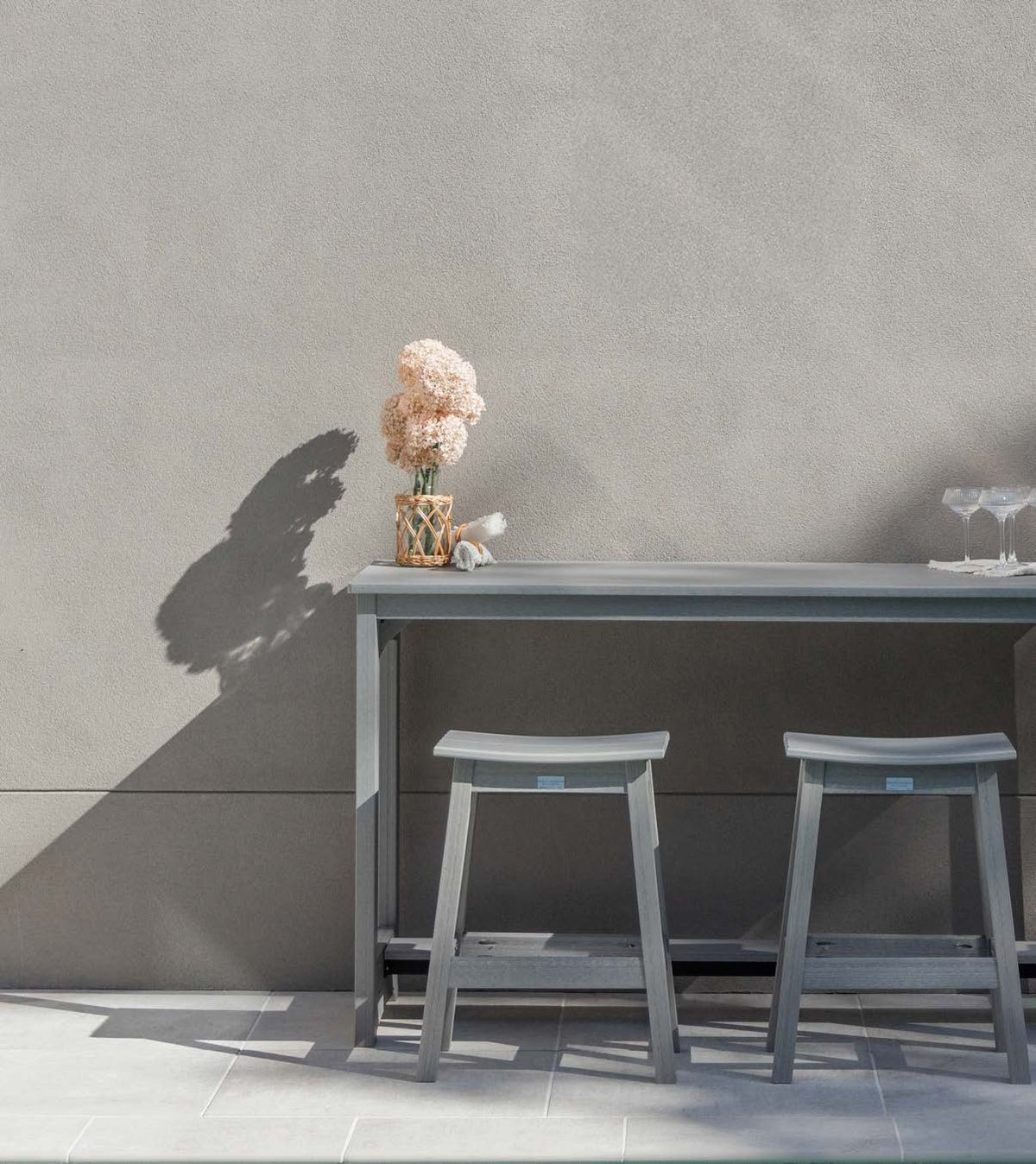 Berlin Gardens Balcony collection: gray balcony table and stools against a wall