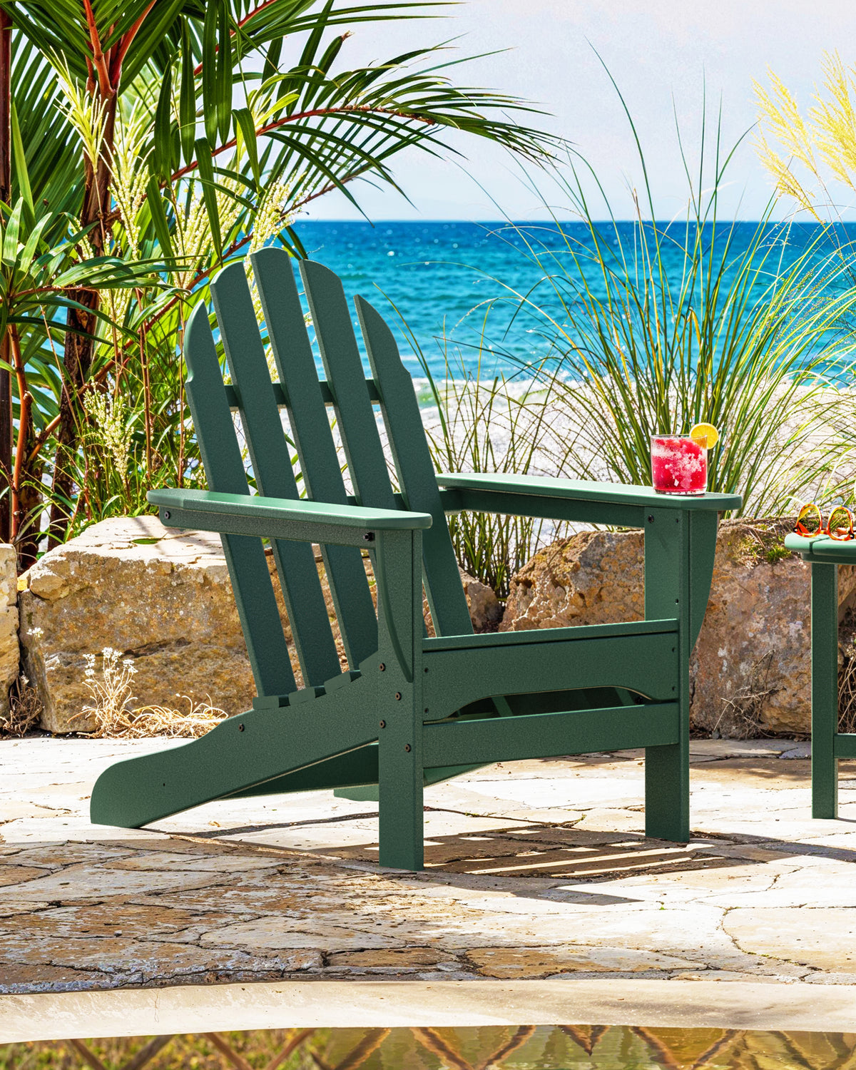 POLYWOOD Classic Adirondack Chair in Green in an outdoor setting