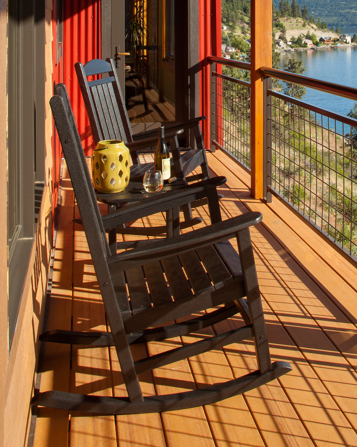 Lifestyle photo of the POLYWOOD Presidential 3-Piece Rocking Chair Set with 18" South Beach Side Table in Black