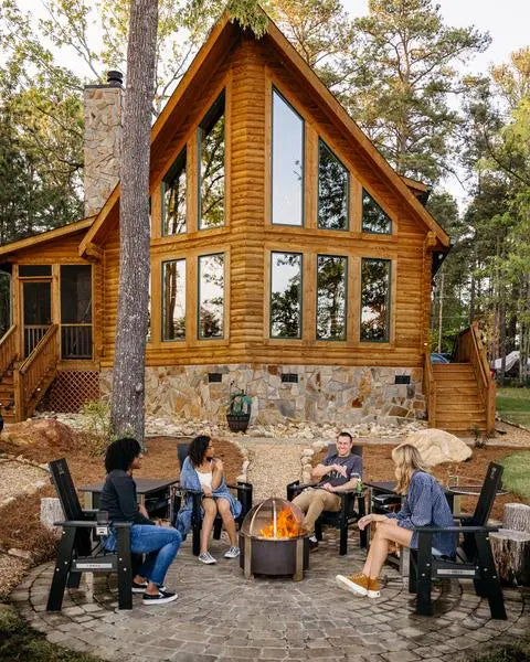 people sitting around a breeo fire pit