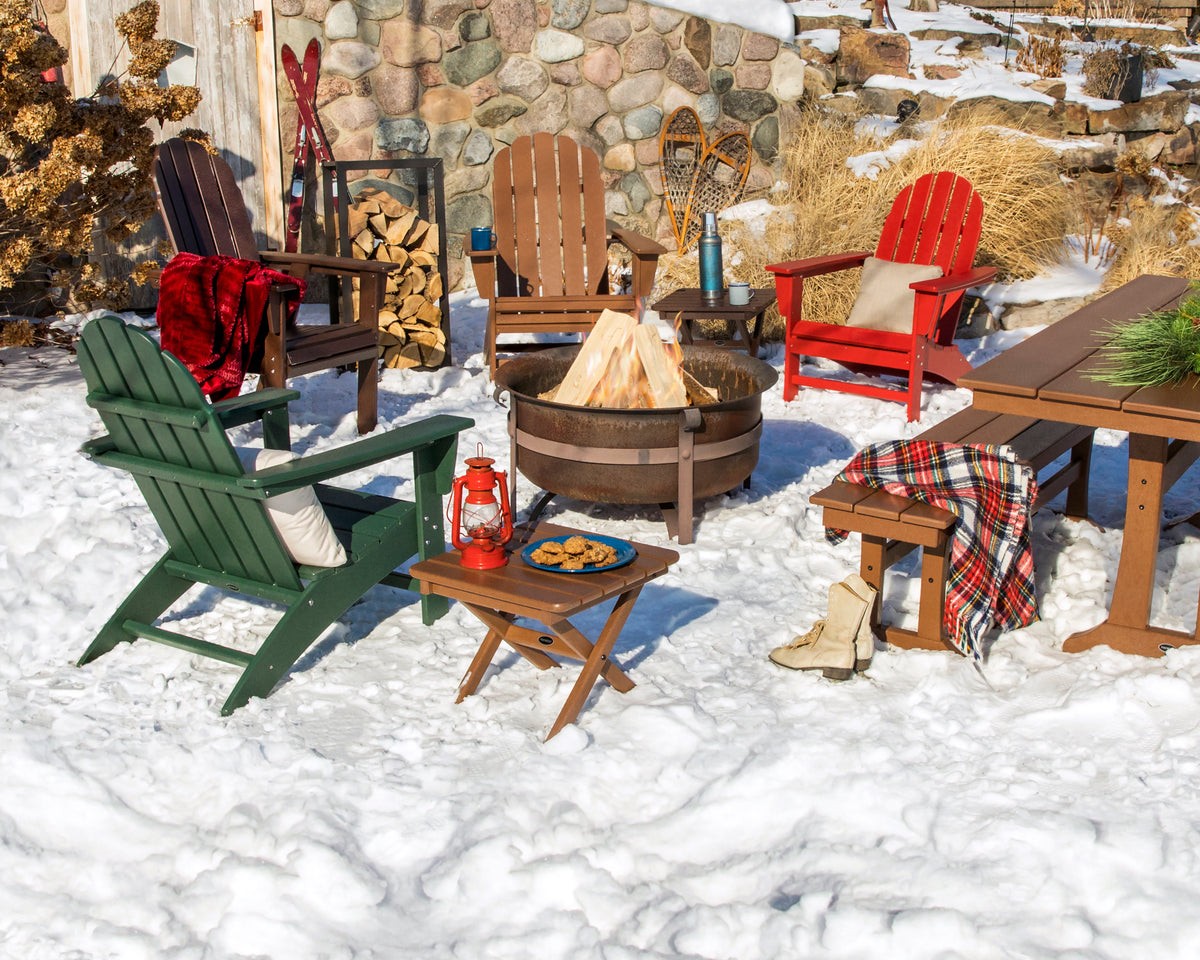 Lifestyle photo of the POLYWOOD Vineyard Adirondack Chair in Green