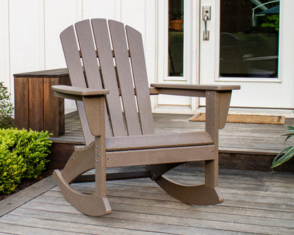 POLYWOOD Nautical Adirondack Rocking Chair in Vintage Sahara on a front porch beside white French doors