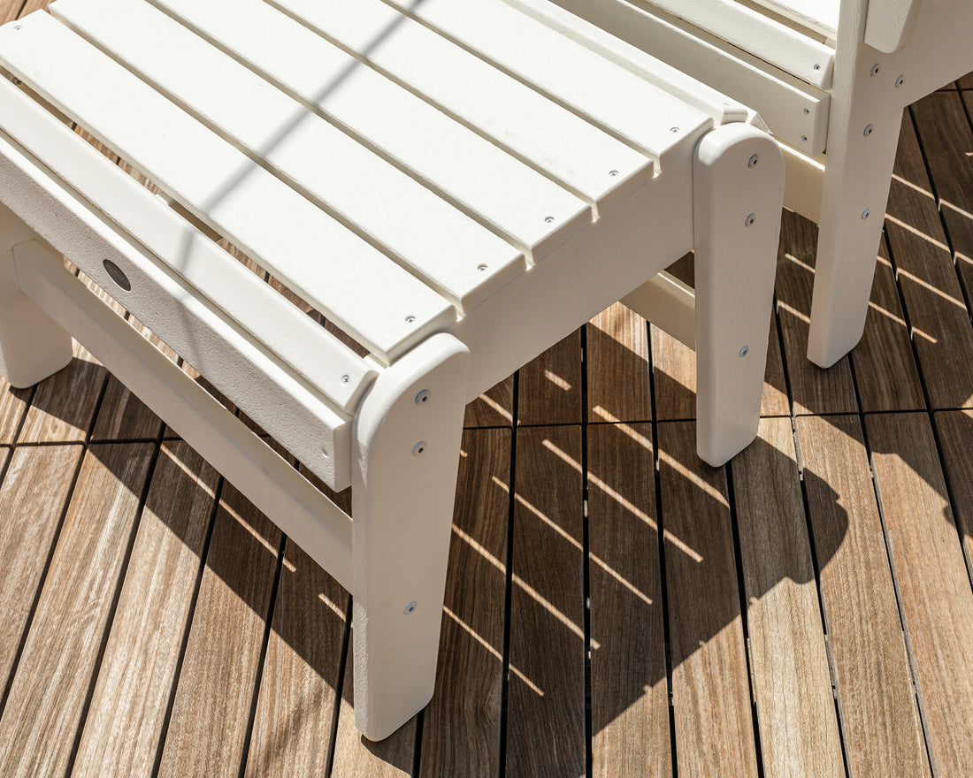 POLYWOOD Grand Upright Adirondack Ottoman in White in an outdoor setting