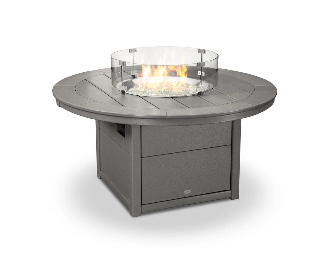 Round outdoor fire table with glass cover on a white background