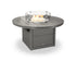 Round outdoor fire table with glass cover on a white background