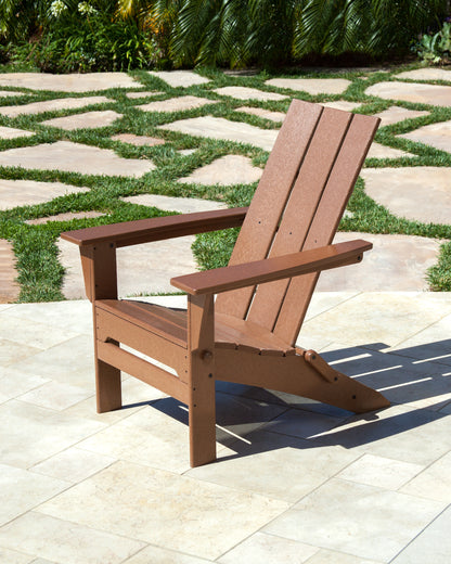 Lifestyle photo of the POLYWOOD Modern Folding Adirondack in Teak