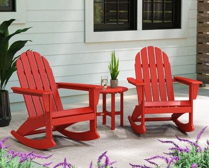 Lifestyle photo of the POLYWOOD Vineyard 3-Piece Adirondack Rocking Chair Set with 18" Round Table in Sunset Red