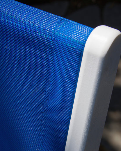 Close-up of a bright blue sling against the White POLYWOOD lumber frame