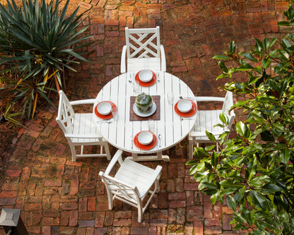 POLYWOOD 48" Round Farmhouse Dining Table in White in an outdoor setting