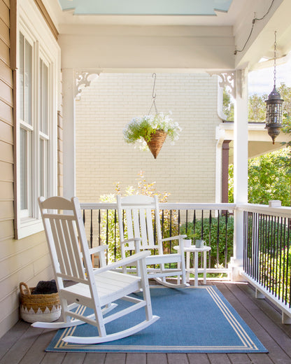POLYWOOD Presidential 3-Piece Rocker Set with Round Side Table in White in an outdoor setting