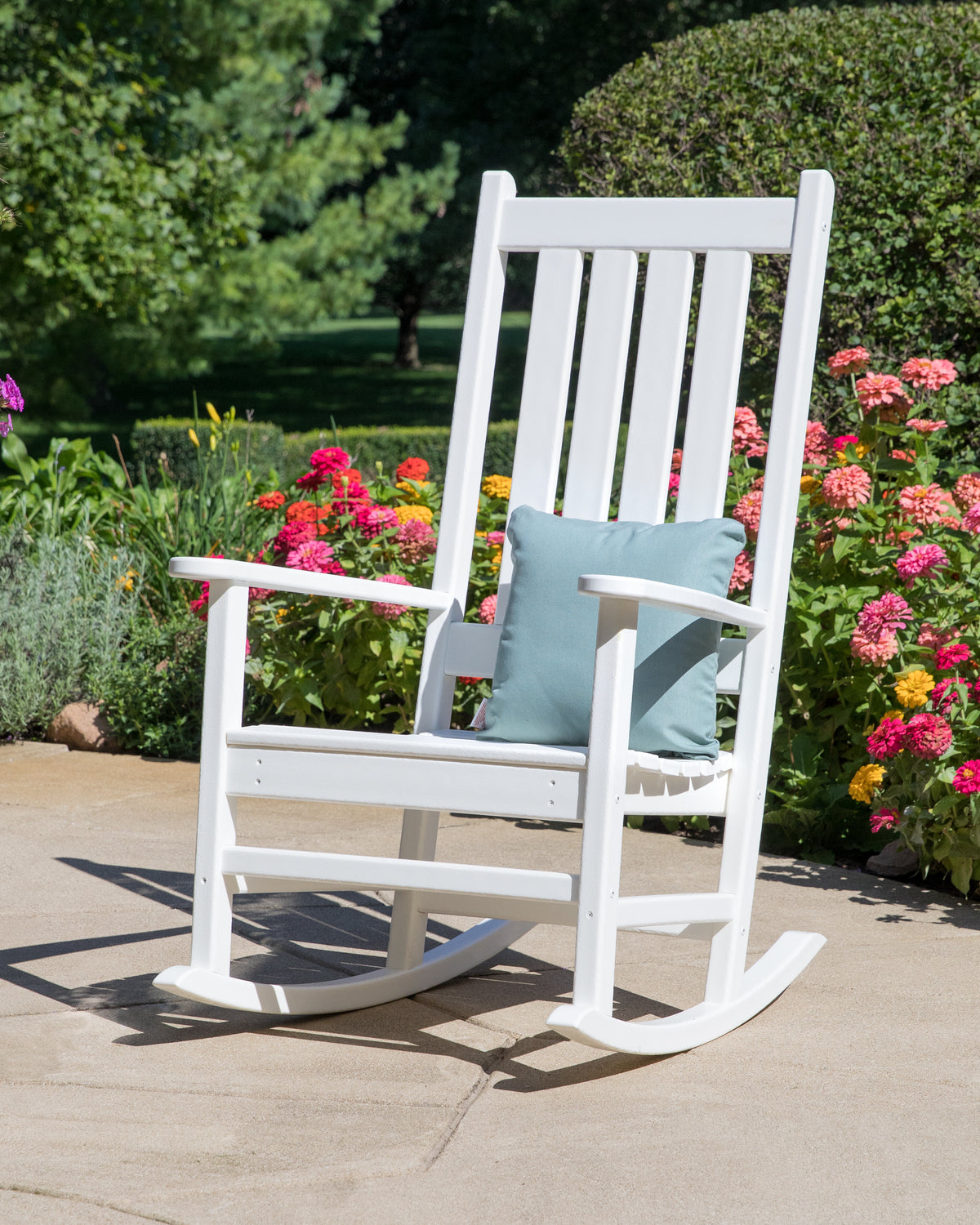 Lifestyle photo of the POLYWOOD Vineyard Porch Rocking Chair in White
