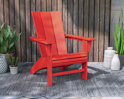 Lifestyle photo of the POLYWOOD Modern Curveback Adirondack Chair in Sunset Red