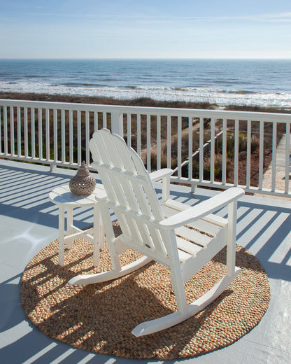 POLYWOOD Classic Adirondack Rocking Chair in White in an outdoor setting
