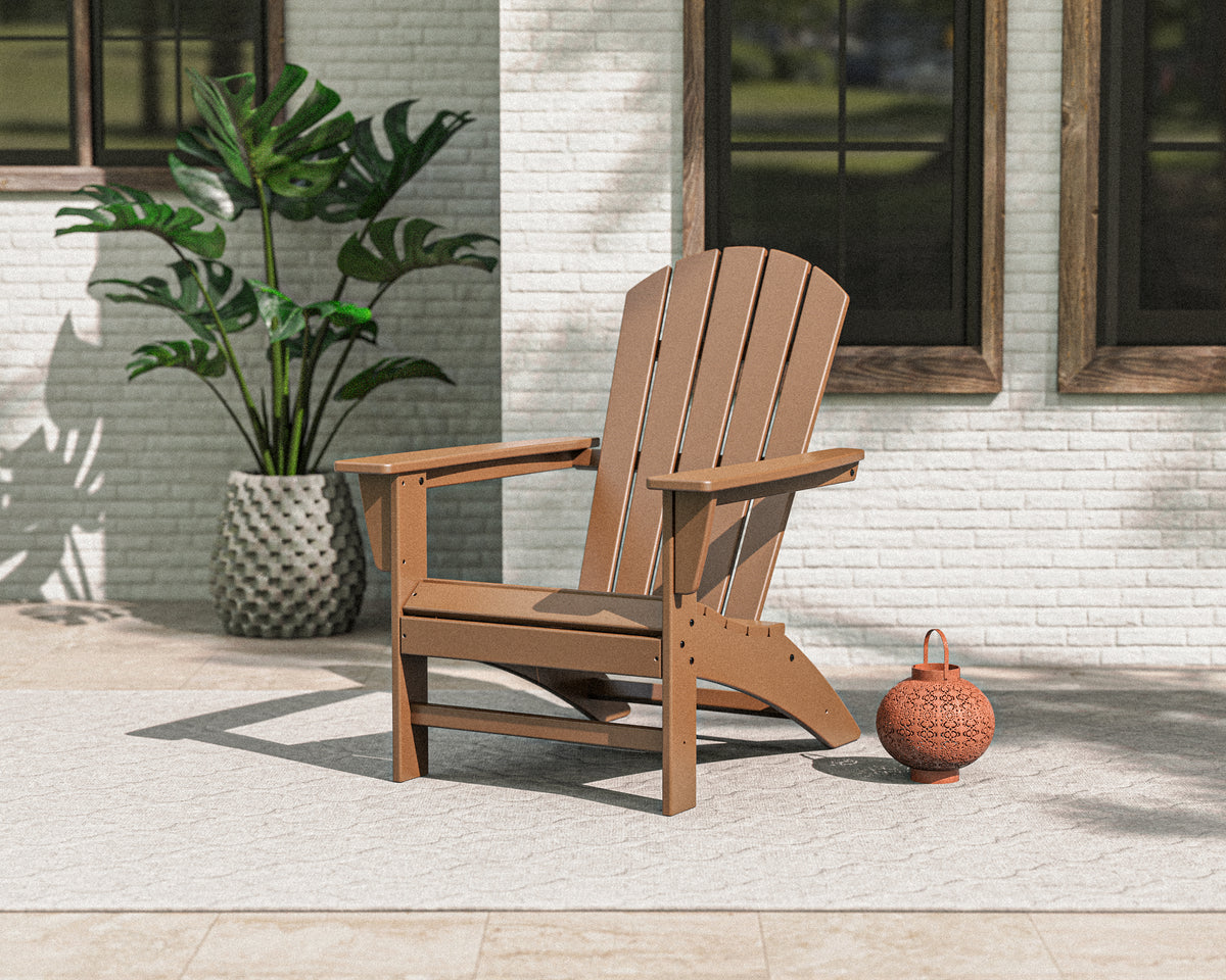 Lifestyle photo of the POLYWOOD Nautical Adirondack Chair in Teak