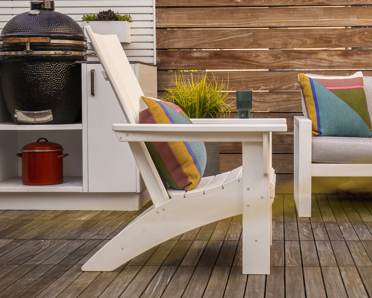 Second photo of the POLYWOOD Modern Grand Adirondack Chair in White in an outdoor setting