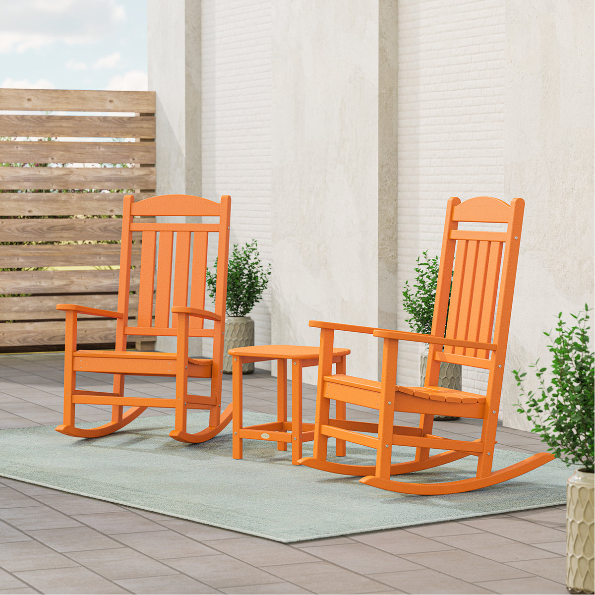 Lifestyle photo of the POLYWOOD Presidential 3-Piece Rocking Chair Set with 18" South Beach Side Table in Tangerine