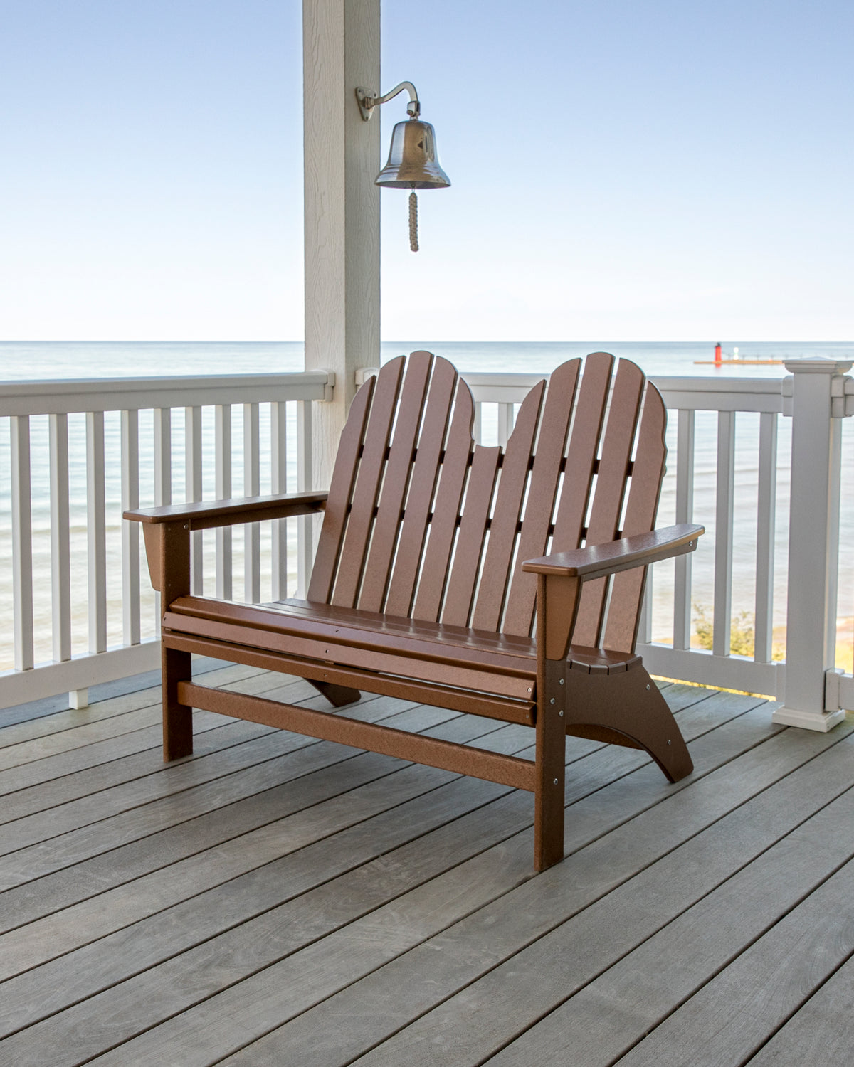 Teak POLYWOOD Vineyard 48" Adirondack Bench on a coastal porch overlooking the water