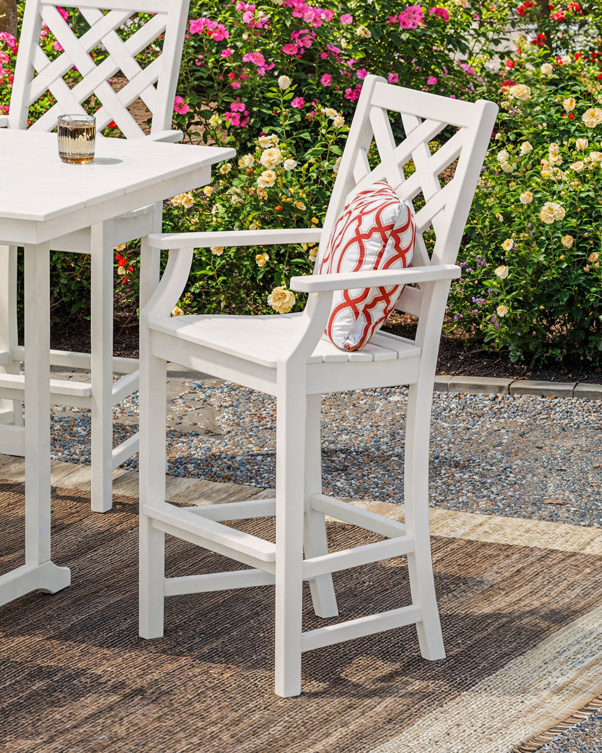 POLYWOOD Wovendale Bar Arm Chair in White in an outdoor setting