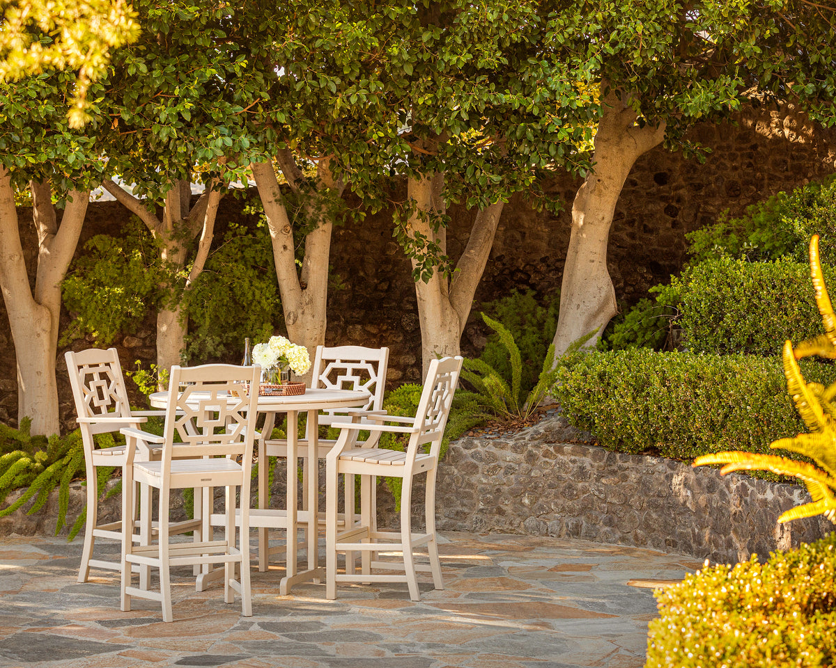 POLYWOOD Chinoiserie Bar Arm Chair in Sand in an outdoor setting (3)